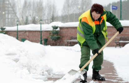 man shoveling snow in his driveway