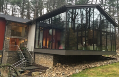 front of house showing all-window sunroom